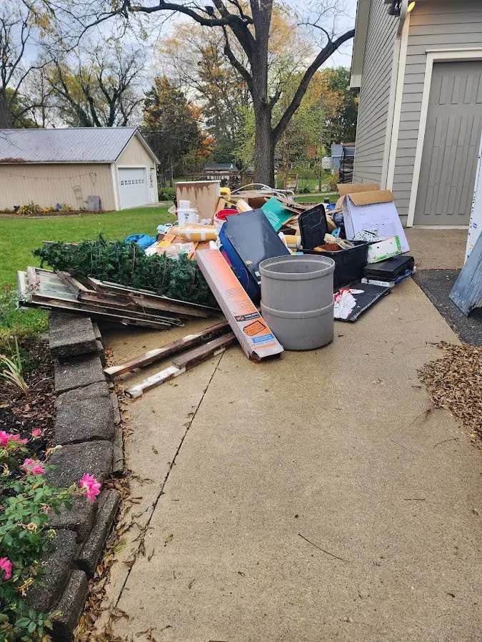 Dumpster being loaded with debris for Estate Cleanout Dumpster Rental in Cusseta-Chattahoochee County